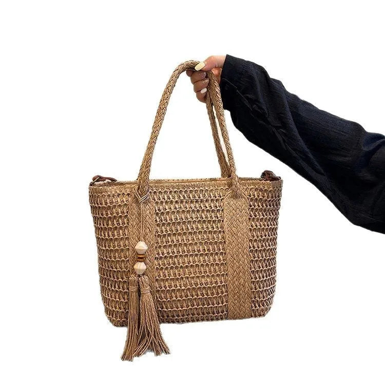 Large straw crossbody bag with woven raffia construction and polyester lining
