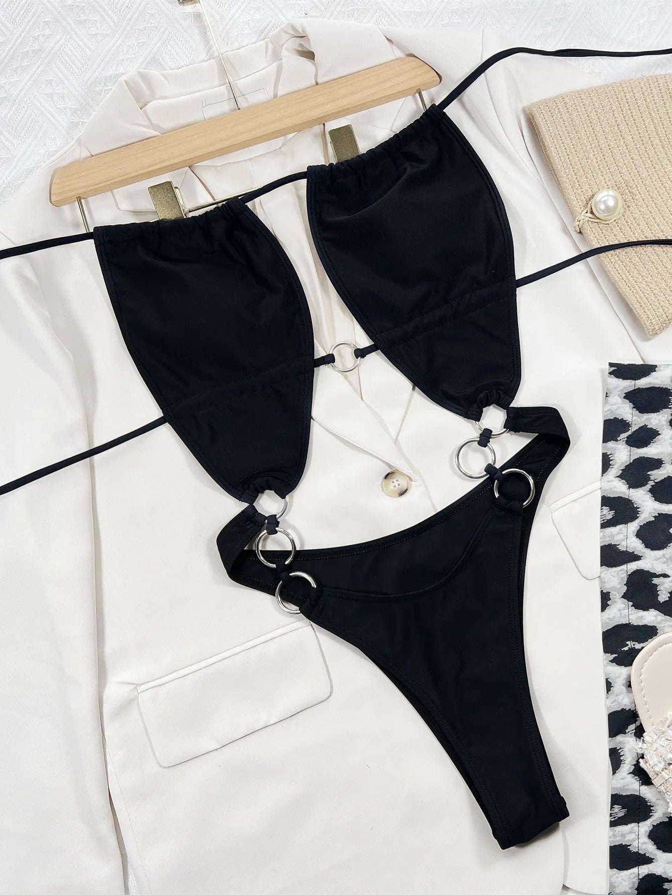 Black sleeveless women's one-piece swimsuit on mannequin showing front design