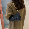Brown pleated PU leather women's baguette shoulder bag with a chain strap and soft carry handle.