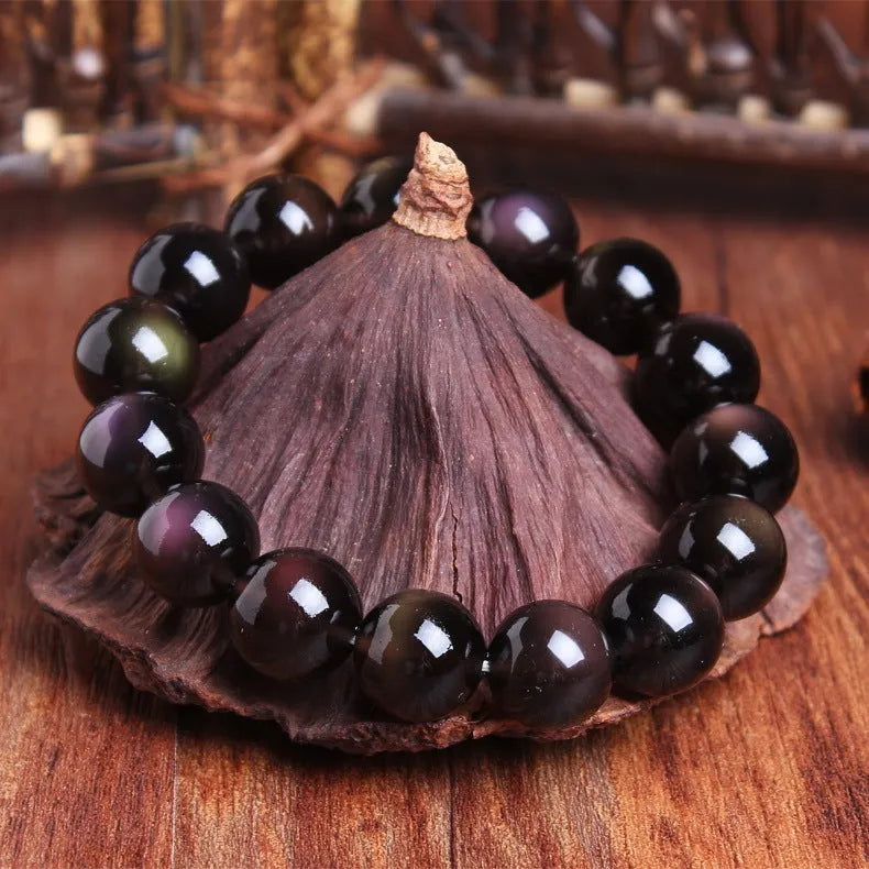 Polished crystal Pi Xiu bracelet with geometric ice stone beads on a wrist.
