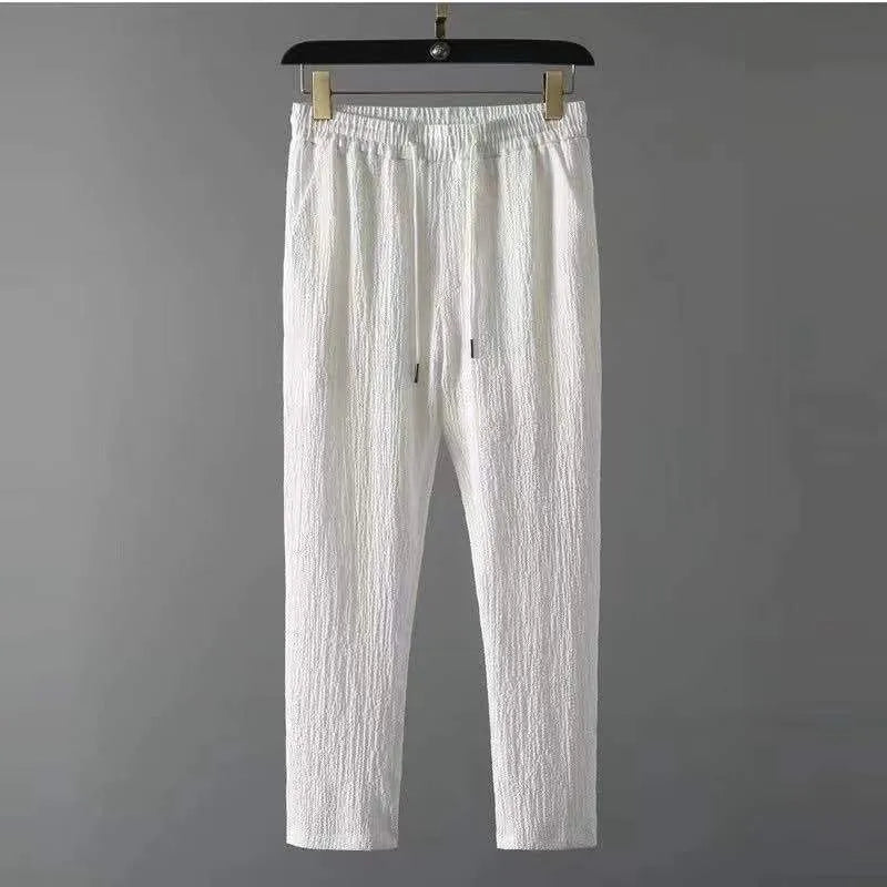 Men's leisure suit with short sleeve top and drawstring trousers in black and white, polyester fabric, loose fit