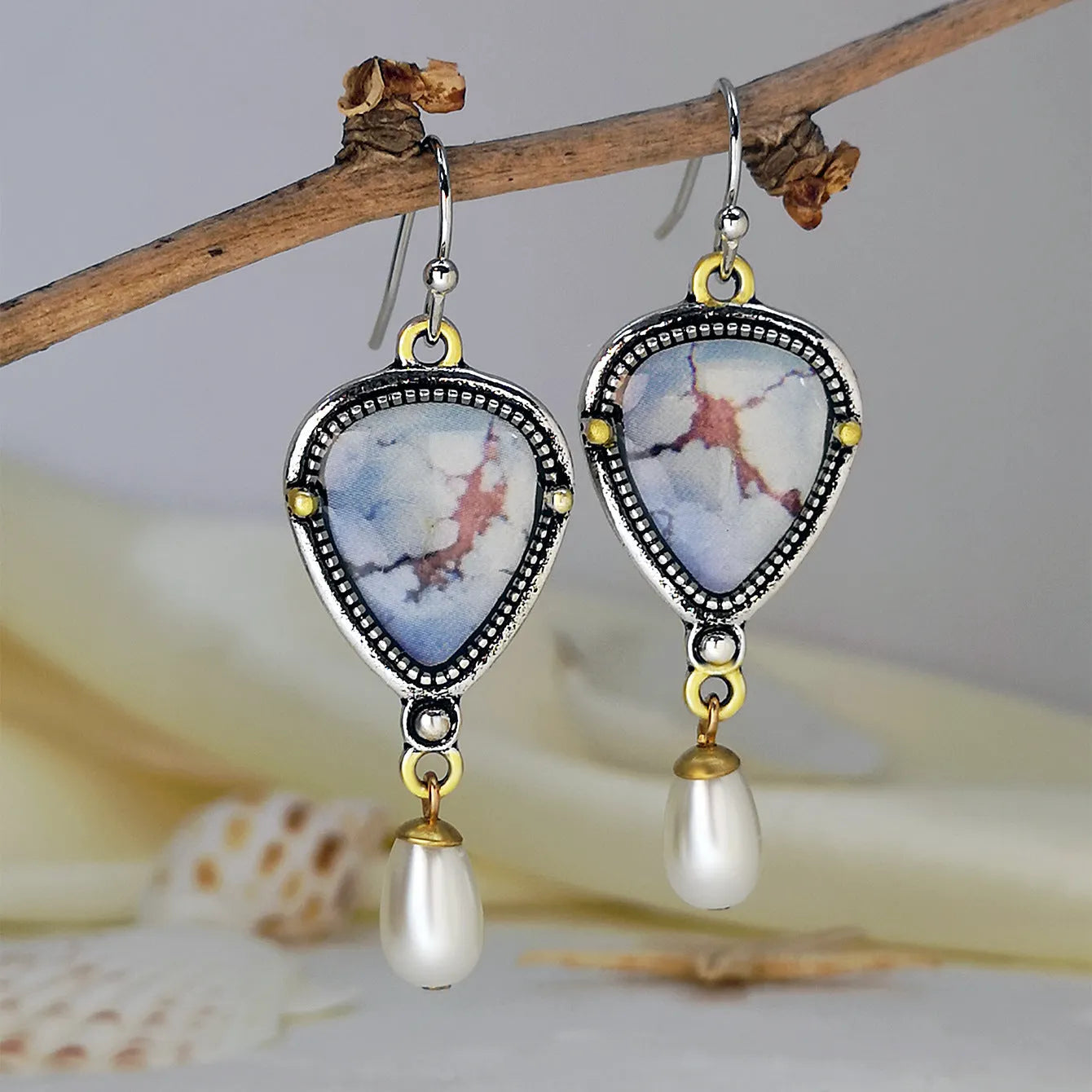 Blue retro bohemian drop earrings with synthetic opal and pearl details on electroplated metal
