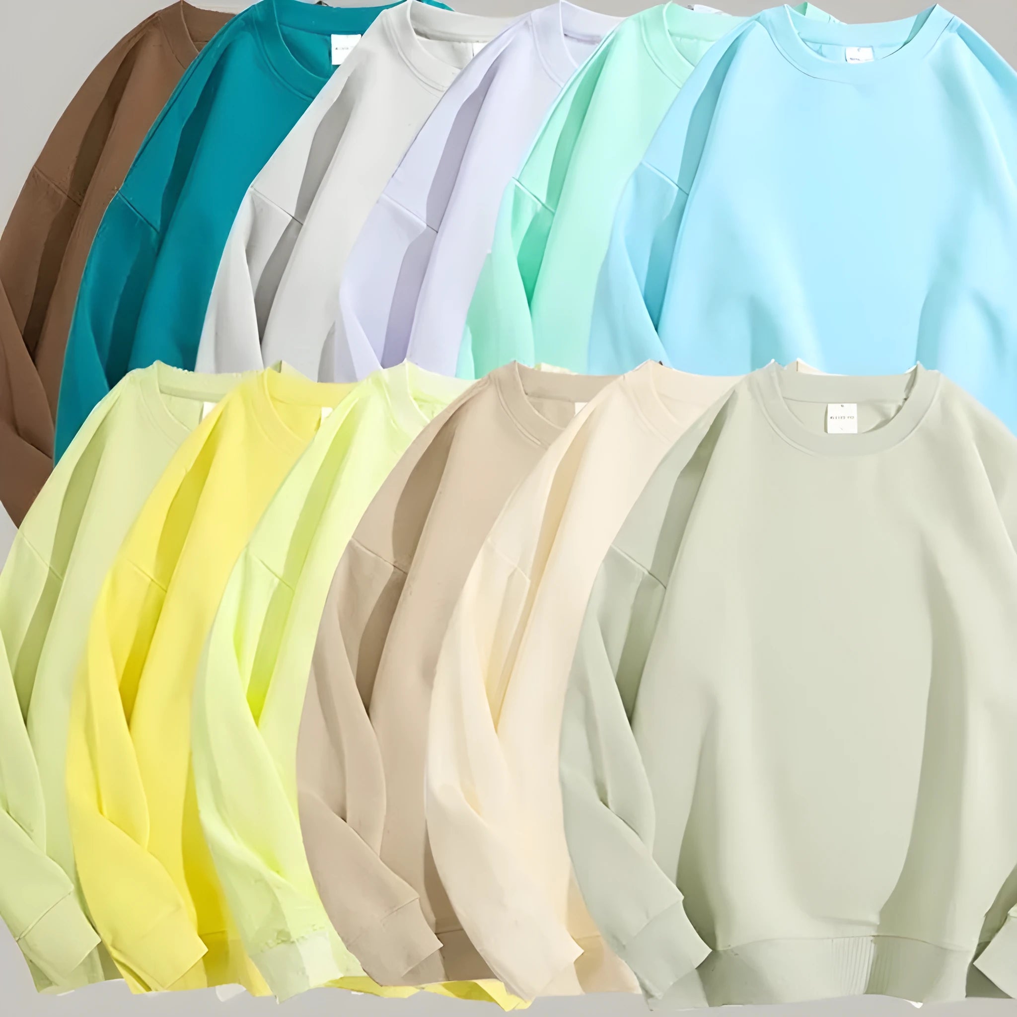 A woman wearing a loose, light blue, cotton off shoulder sweater with long sleeves and a round neck.