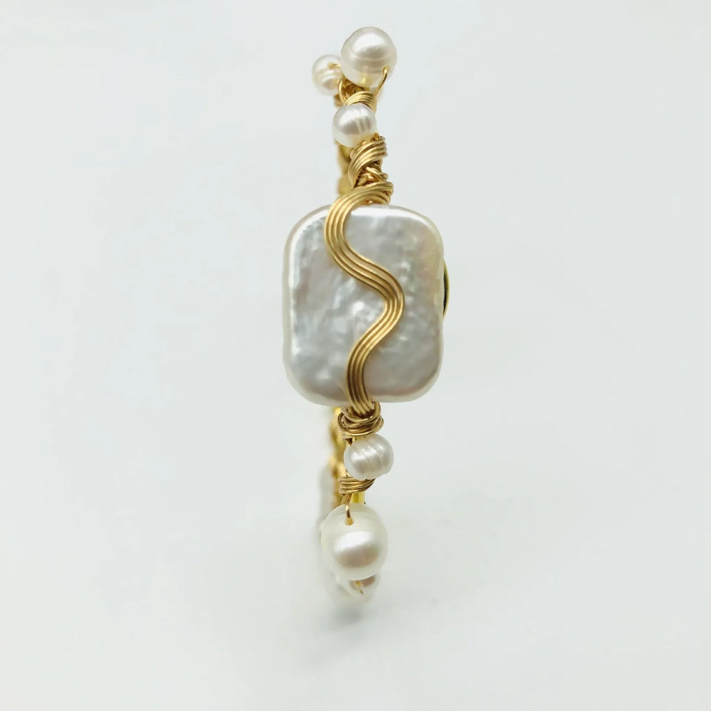 Natural freshwater pearl handmade wire-wrapped bracelet in gold titanium steel on wrist