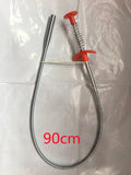 Black flexible sewer dredger spring drain cleaning tool with a textured grip on a white background.