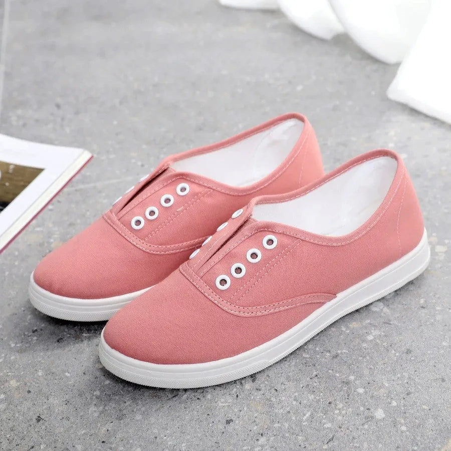 A pair of low-top canvas casual shoes on a white background, shown in one of the available colours.