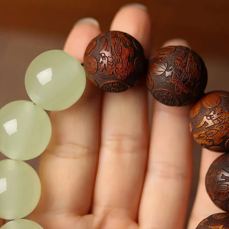 Rosewood bracelet with carved Fu character design showing 20mm beads on wrist