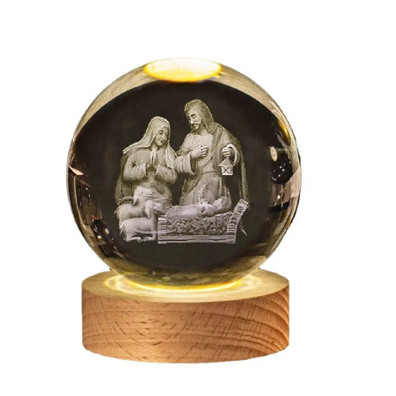 White crystal ball desk ornament on a solid wood base with a warm light, showing religious motif options.