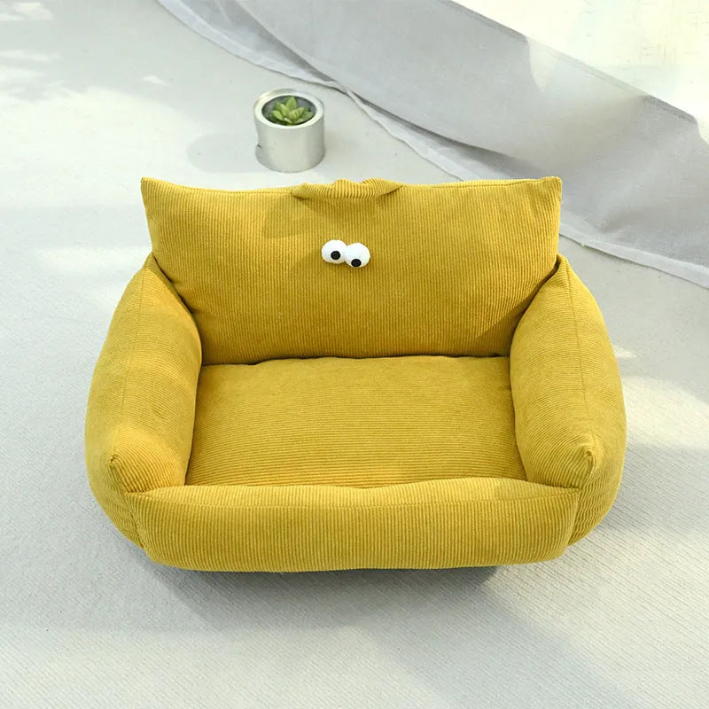 Cartoon big eye pet sofa kennel bed in blue, showing plush Moon velvet material and large adhesive eyes.