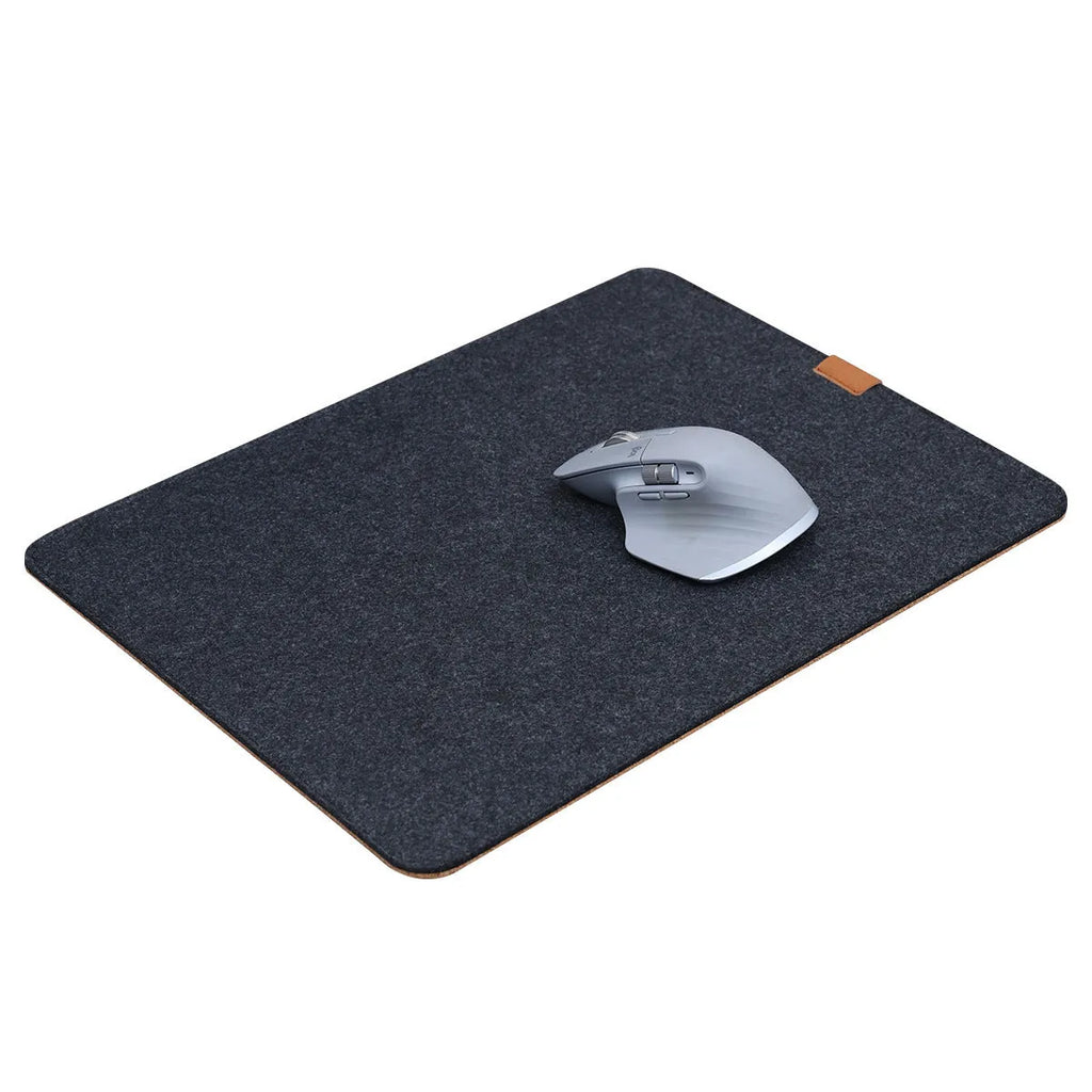 Oversized winter warm desk mat with felt and cork construction on wooden desk