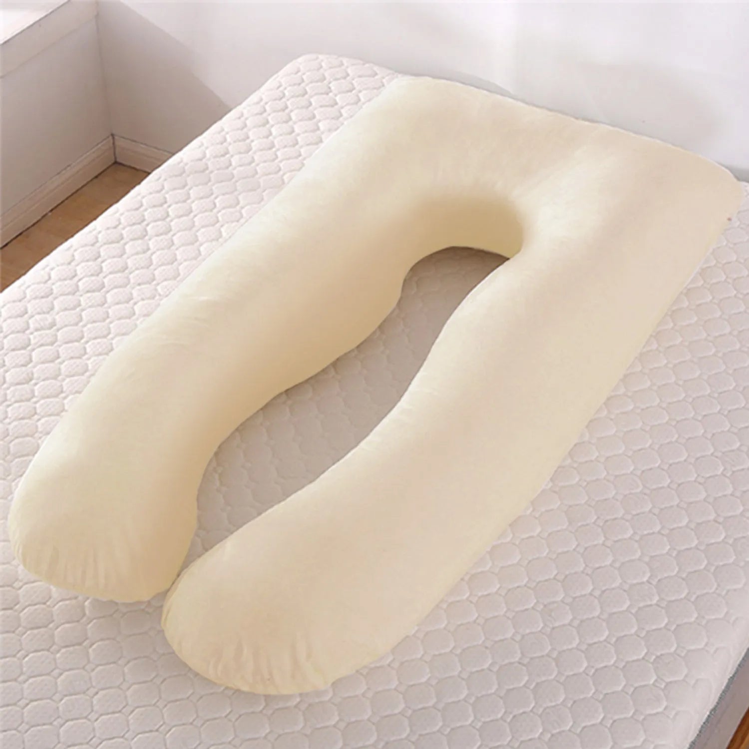 U-shaped pregnancy pillow in light blue ice silk fabric on a bed.