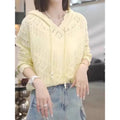 Woman wearing a blue hollow crochet hooded longsuit undershirt with long sleeves.