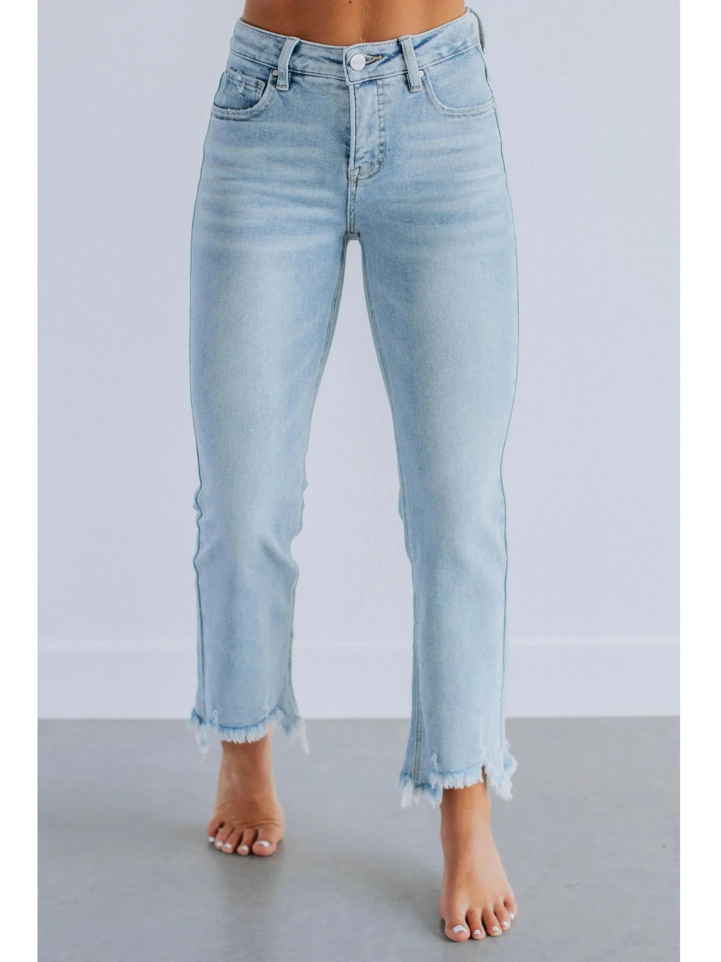Women's dark blue cotton denim jeans with hand-worn distressing detail on the front.