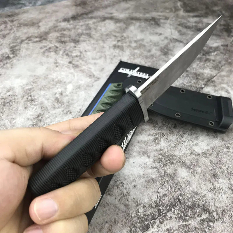 Mini fixed blade knife with 440C steel blade and ABS handle on a wooden surface