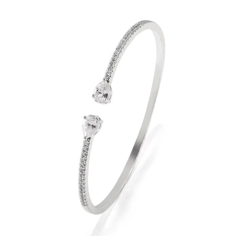 Multi-zircon copper bracelet with zircon inlaid detailing available in white or blue colour