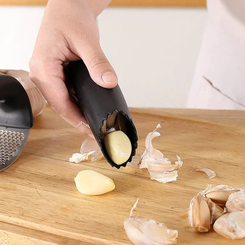 Stainless steel garlic press in black, blue, green, and pink colour options showing 11 x 7 cm dimensions