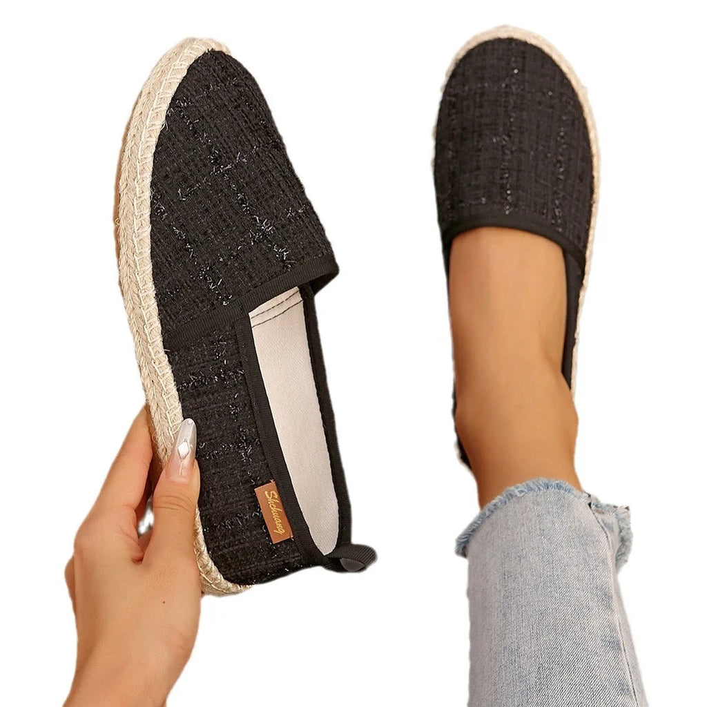 Beige fisherman shoes with canvas upper and rope sole on a flat background