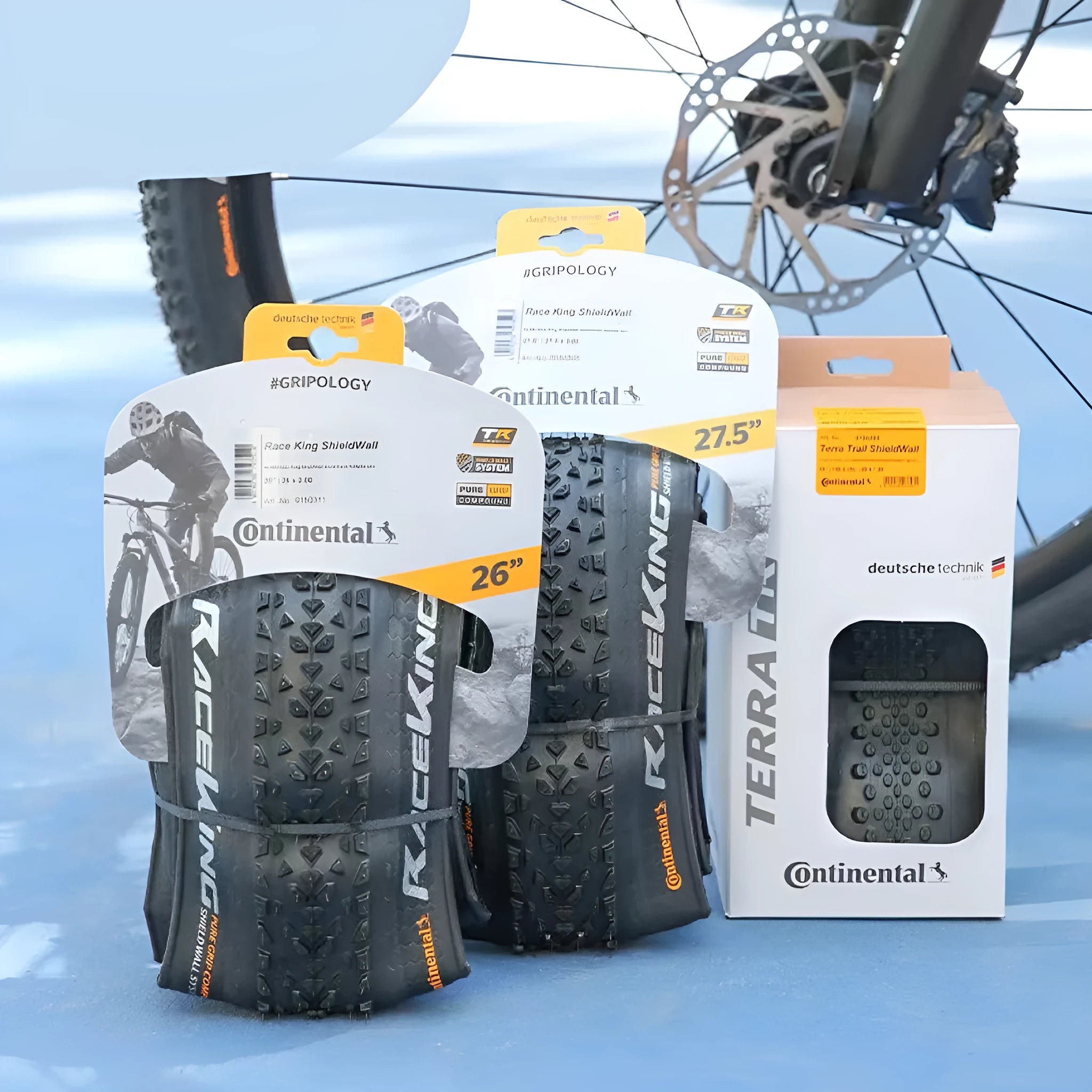 A folding mountain bike tyre in yellow or white, showing tread pattern, available in 26, 27.5 and 29 inch sizes.