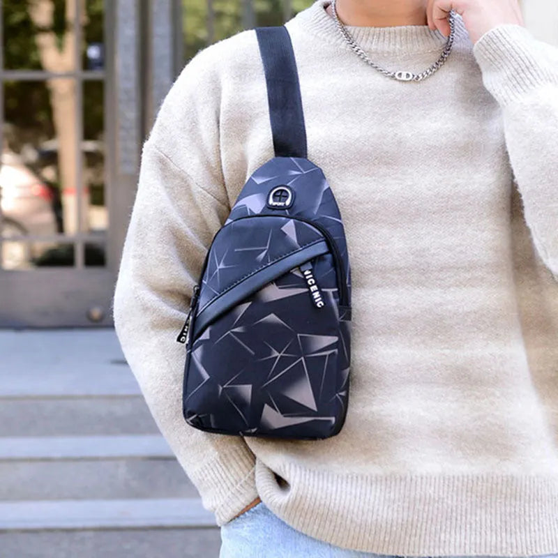 Medium blue crossbody chest bag for men with a visible earphone hole and zipper opening.