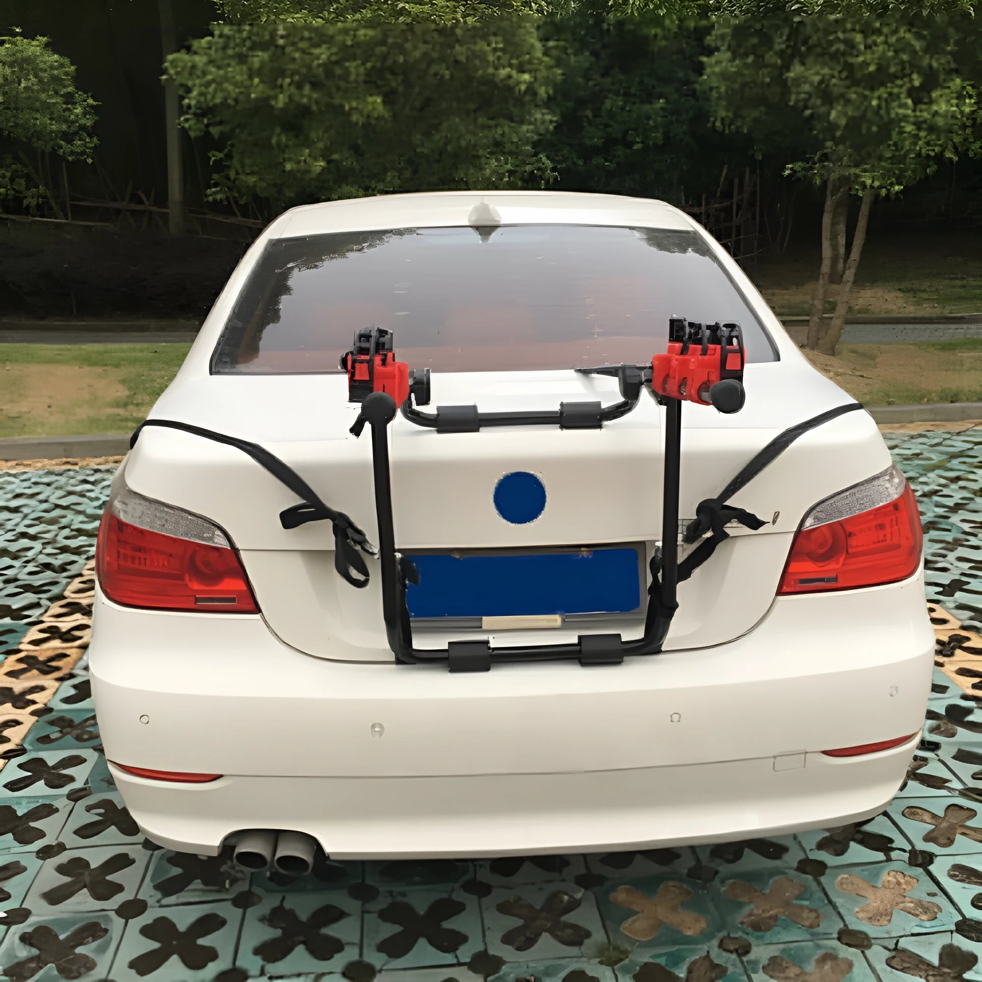 Black and red iron trunk mounted bike rack with protective sponge padding, shown with fastening straps.