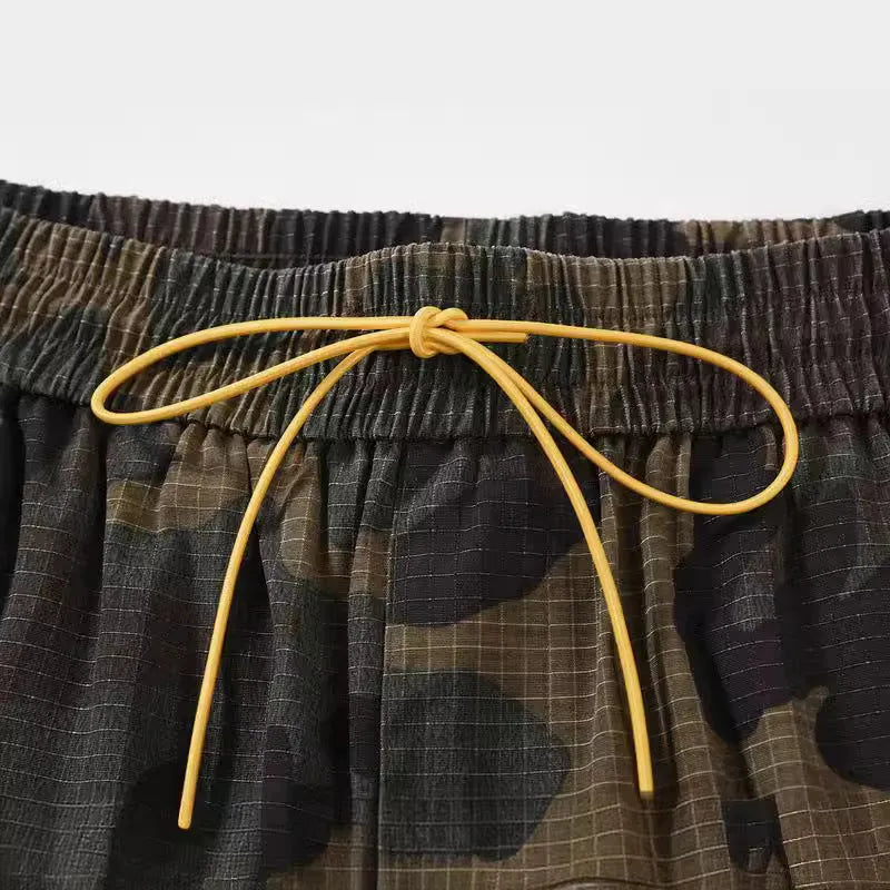 Men's green multi-bag washed camouflage cotton shorts with a loose fit on a mid-waist.