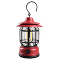 Dark green portable camping lantern with head lamp function on a table