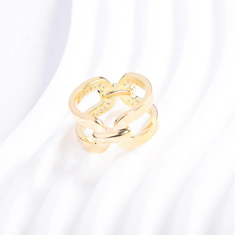 Round copper scarf ring with electroplated gold finish, geometric shape, on a silk scarf