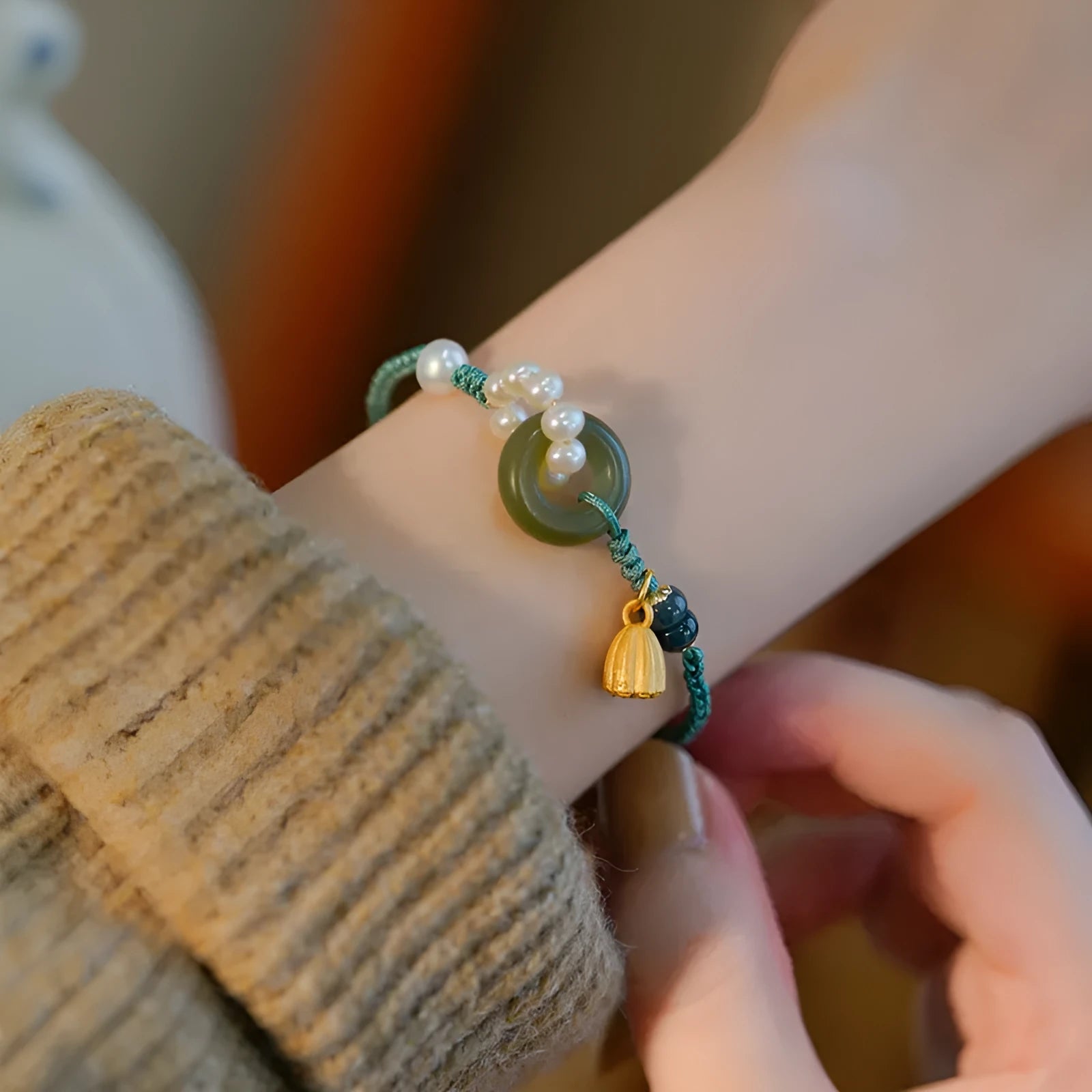 Hand-woven women's watch band with a pearl peace buckle closure on a flexible wire bracelet.