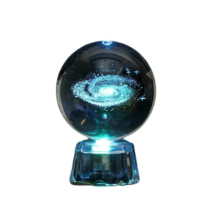 Transparent white crystal ball ornament with inner carving on wooden table with night lamp