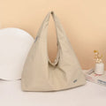 Soft nylon women's underarm bag in heart shape, shown in black, yellow, khaki, or blue.