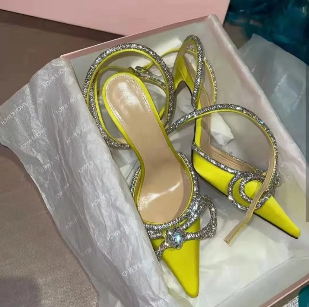 Women's black stiletto heel sandals with a silk back bandage and buckle fastening, shown from the side.