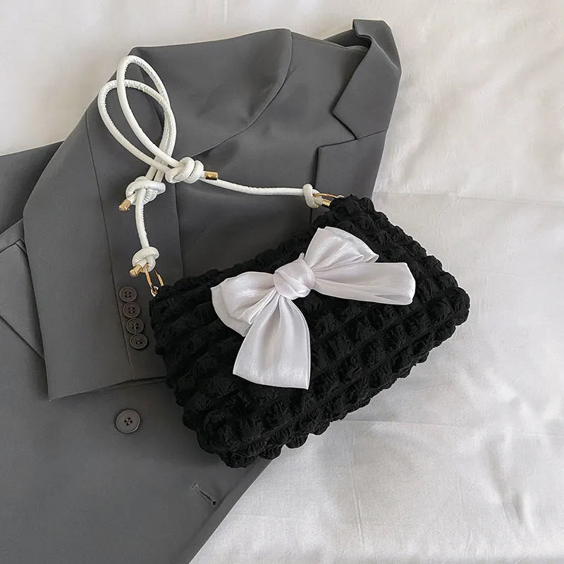 Women's canvas handbag with single shoulder strap in horizontal square shape showing mobile phone compartment