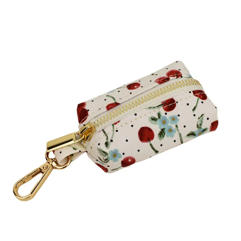 Red cherry print pet collar set with matching leash, vest, and gold buckle on dog model