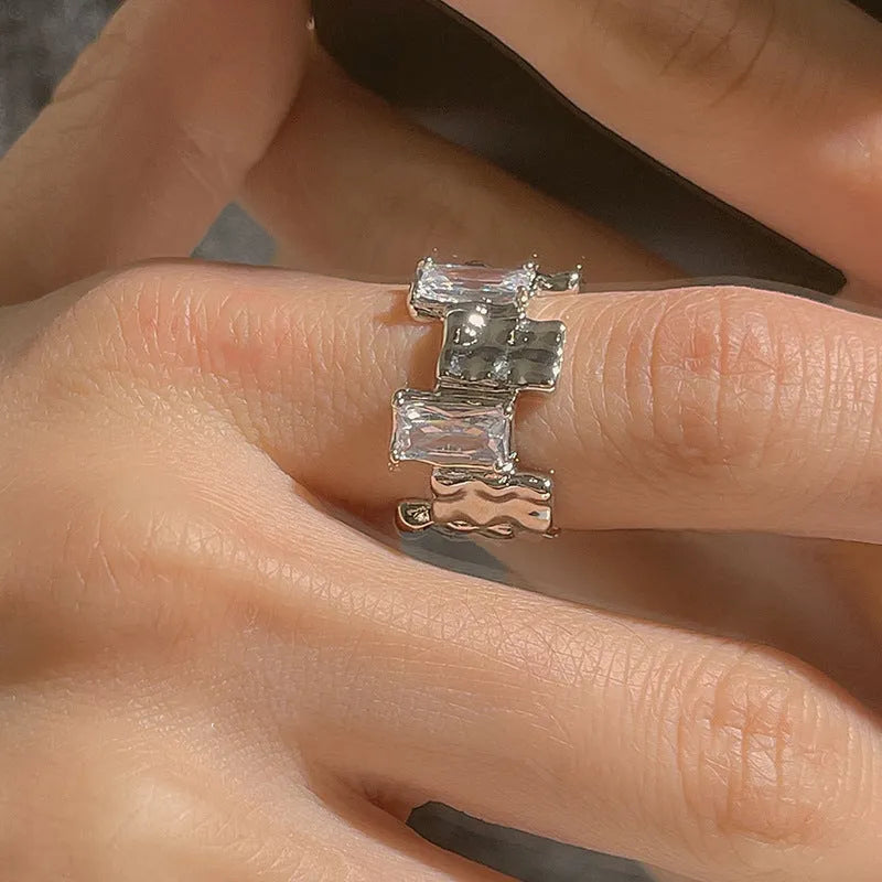 Silver geometric open ring with cross design and zircon centrepiece