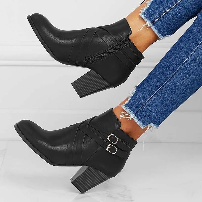 Women's grey short ankle boots with a block heel, side zipper, and buckle strap on a white background.
