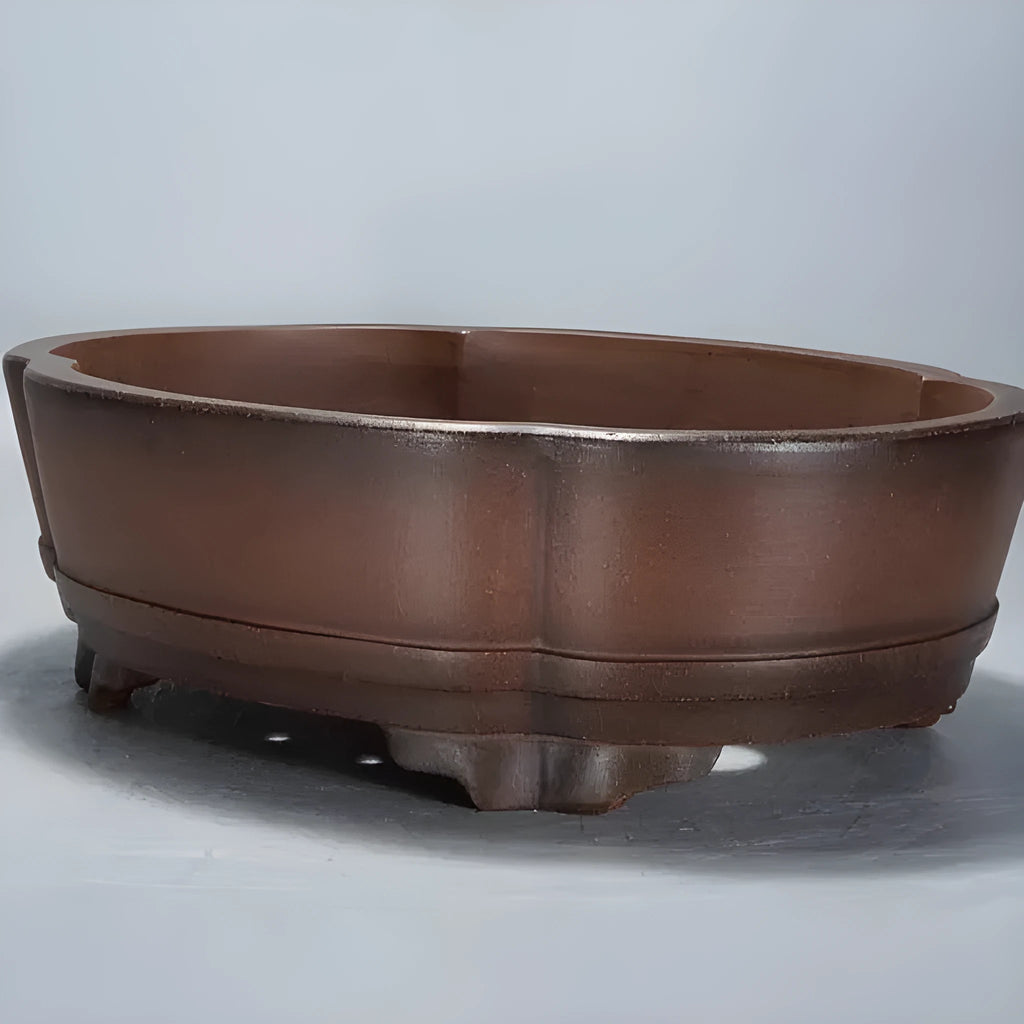 A rectangular purple clay bonsai pot with a simple classical design, shown on a tabletop.