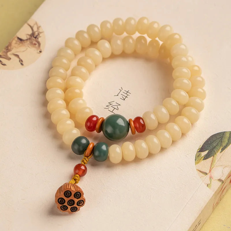 Cream Topaz Bodhi wooden bracelet with flat round beads on a wrist.