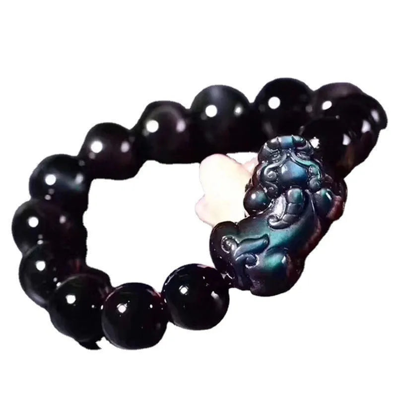 Natural ice colour eye obsidian crystal bracelet on wrist showing bead detail.