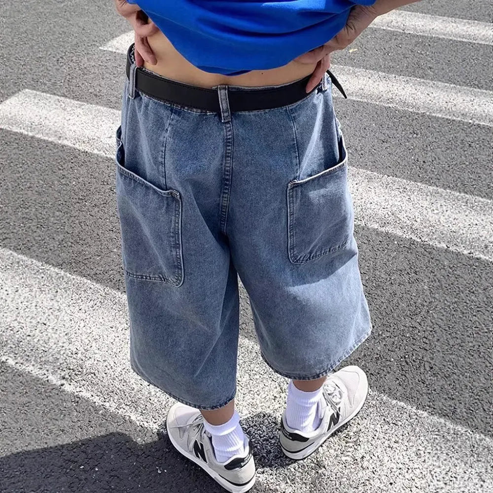 Blue men's high-waist denim pirate shorts with a cropped length and zipper fly.
