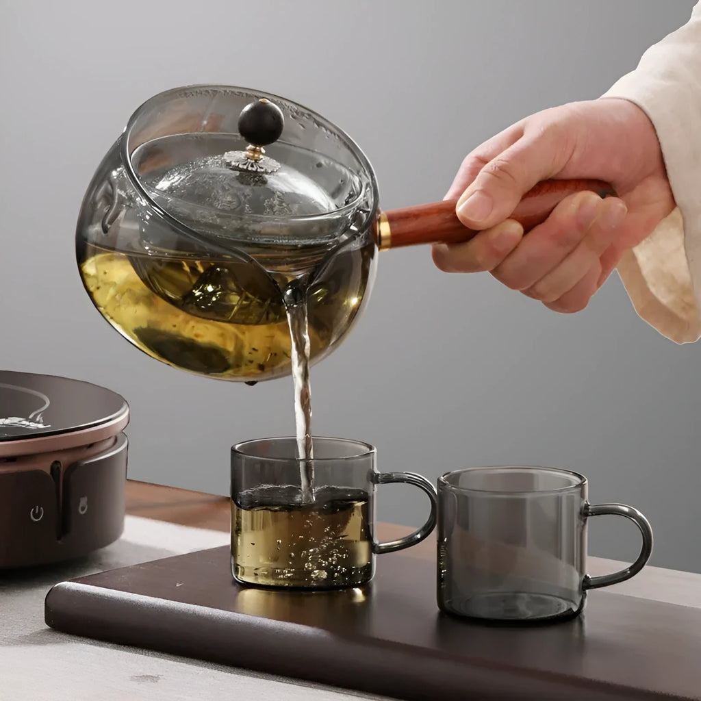 Transparent borosilicate glass teapot with wooden handle and rotation mechanism
