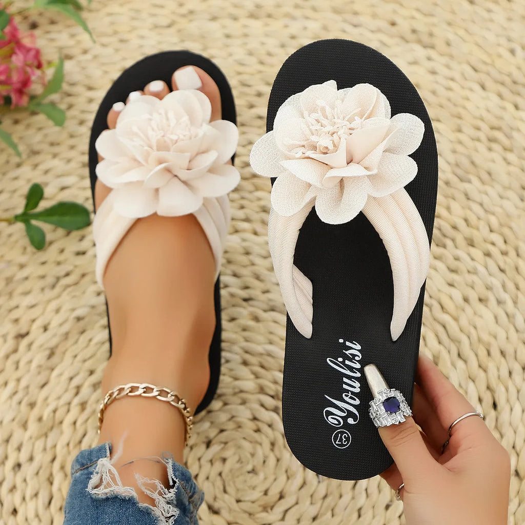 Solid-colour floral flip-flops with a lightweight EVA sole on a plain background.