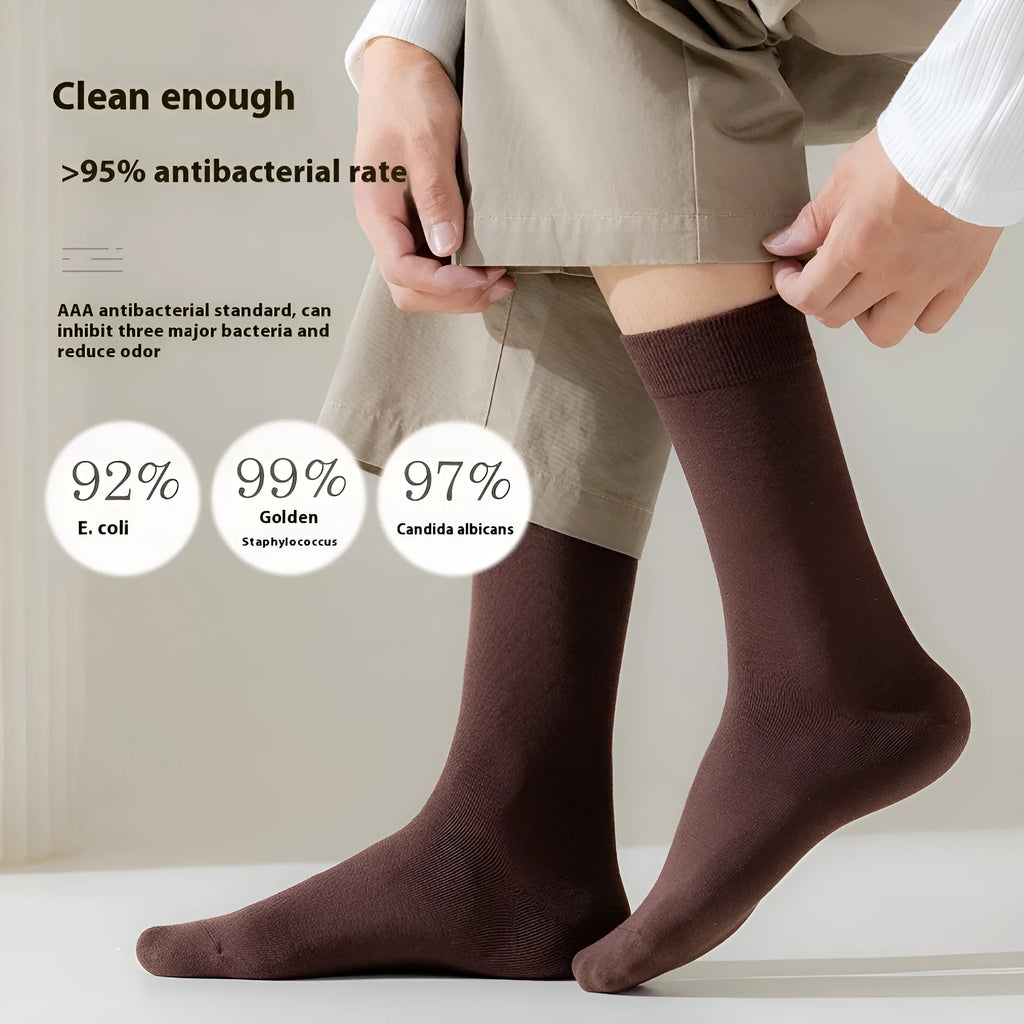 Men's mid-calf combed cotton socks in solid colours like army green, beige, and black on a white background.