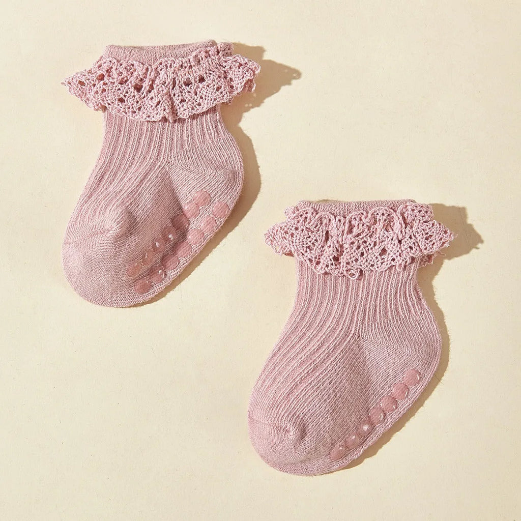 Six pairs of baby girl lace cotton tube socks in mixed colours, short tube length, on white background