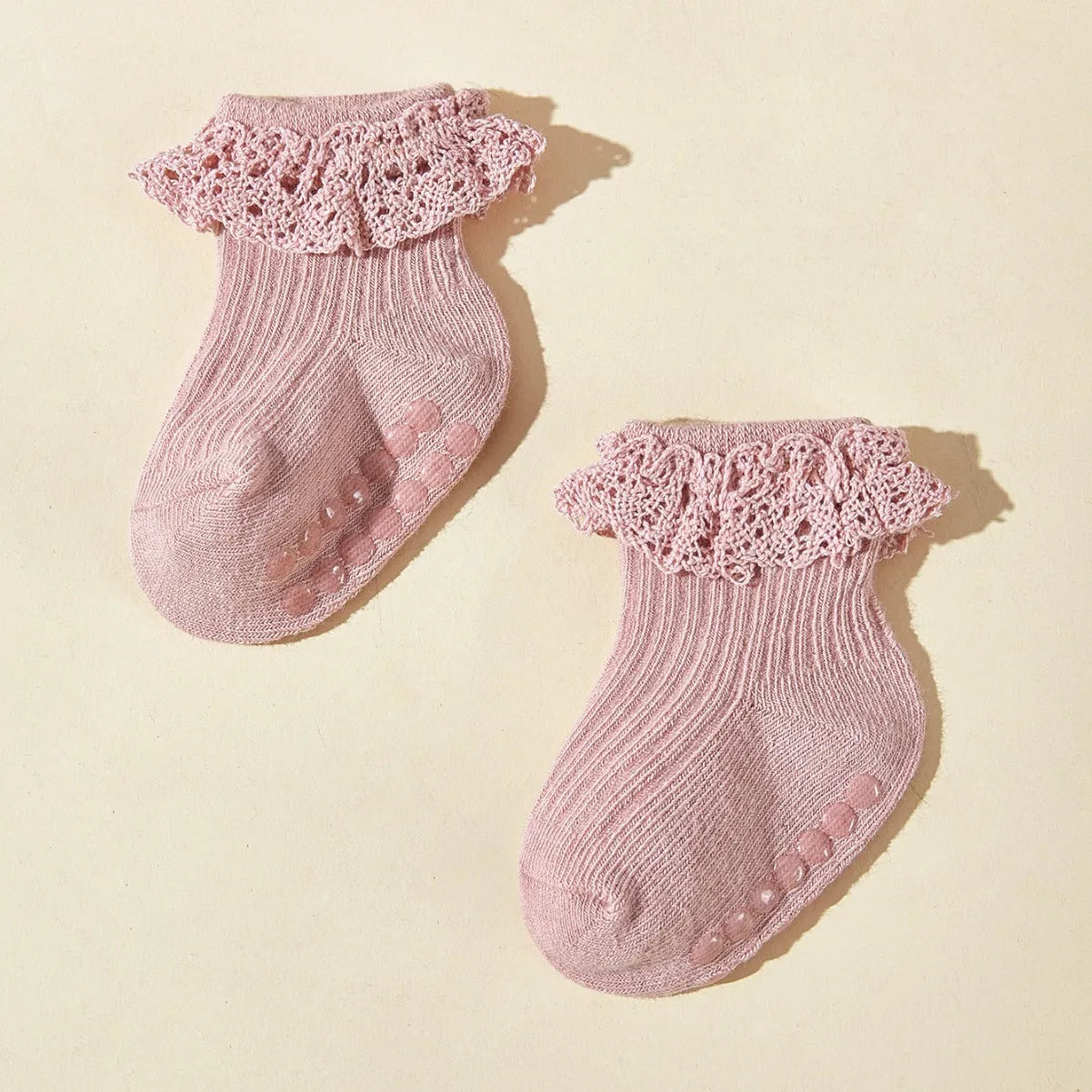 Six pairs of baby girl lace cotton tube socks in mixed colours, short tube length, on white background