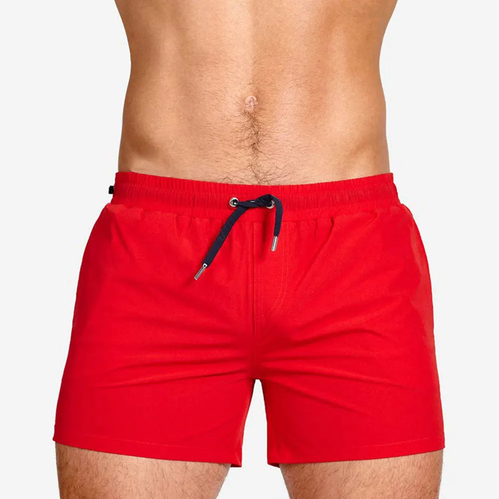 Men's solid colour swimming shorts with mesh lining in army green, shown on a white background.
