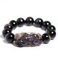 Polished crystal Pi Xiu bracelet with geometric ice stone beads on a wrist.