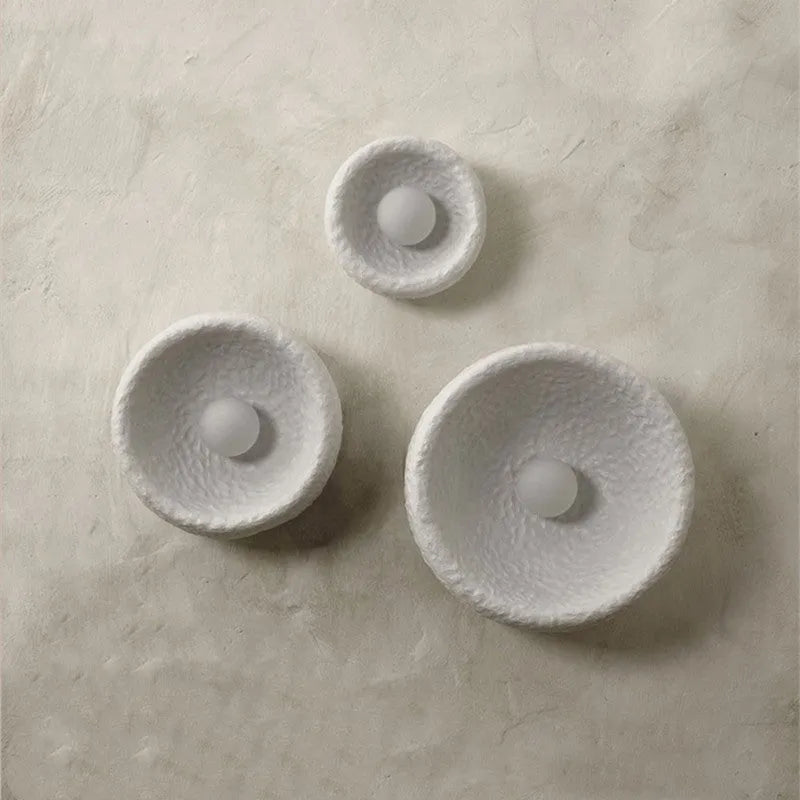 Japanese-style modern wall lamp with white resin shade in three size options.