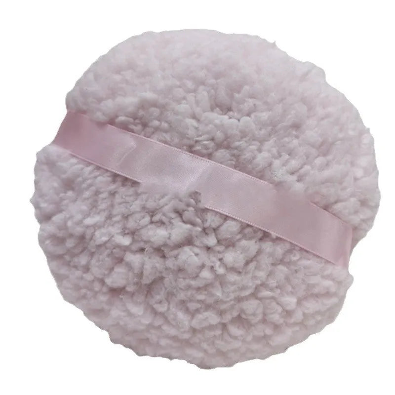 Oversized rectangular plush powder puff in pink, white, or skin colour for dry makeup application.