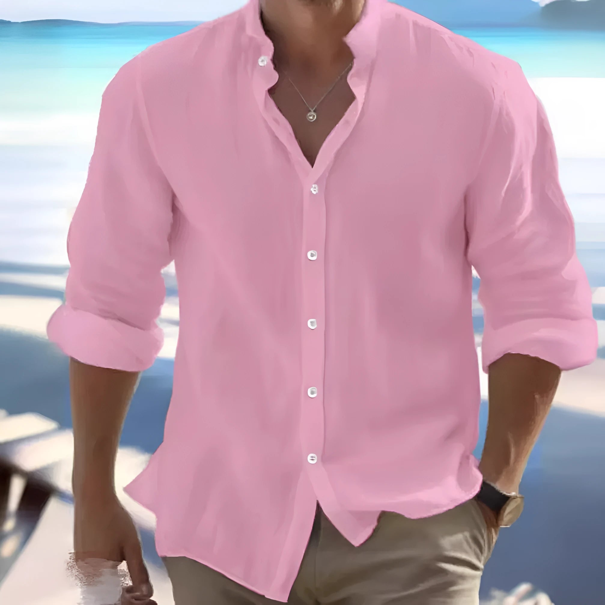 Man wearing a light blue long-staple cotton button-down beach shirt, casual summer style.