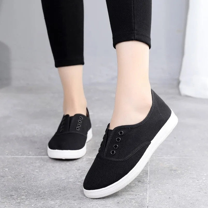 A pair of low-top canvas casual shoes on a white background, shown in one of the available colours.